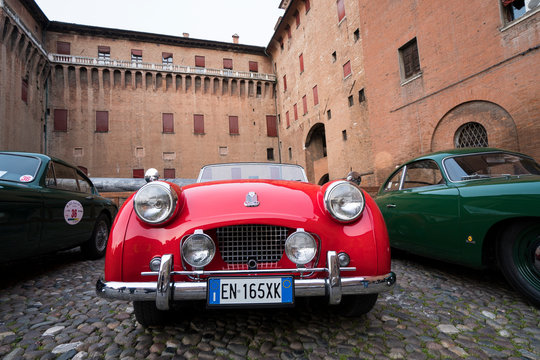 Red classic car, Triumph TR2 during a meeting of historic cars. This model was built in 1955. Ferrara, Italy - March 25, 2017