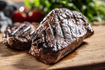 Juicy beef rib eye steak with herbs tomatoes salt and spices