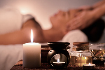 Perfect evening. Woman enjoying face massage and aroma spa