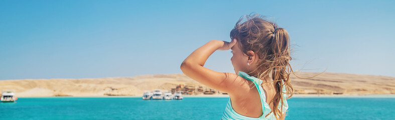 A child on a yacht sailing the sea. Selective focus.