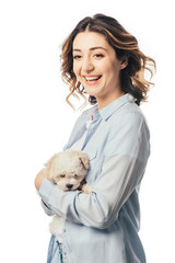 smiling woman holding cute Havanese puppy isolated on white