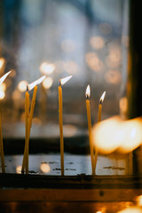 Hand lighting candles in a church
