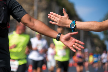 Clap hands of a runner and child fan
