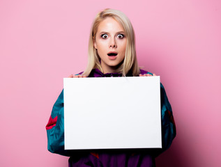 Beautiful blonde woman with banner on pink background