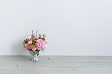 Vase with beautiful bouquet. Flowers in a vase. Floristic composition. 