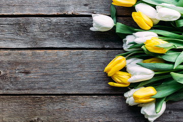 Bouquet of white and yellow tulips on a wooden background. Postcard. Background