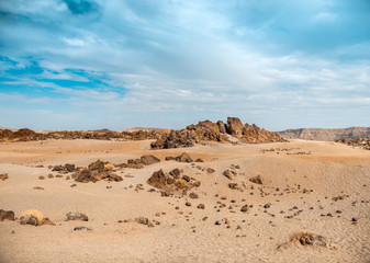 Beautiful landscape of volcanic desert and sharp stones against bright blue sky