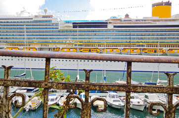 Big Costa Cruises cruise ship liner or cruiseship in port with marina and small boats and yachts in...