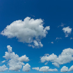 a group of white cumulus clouds in the blue sky as a natural background