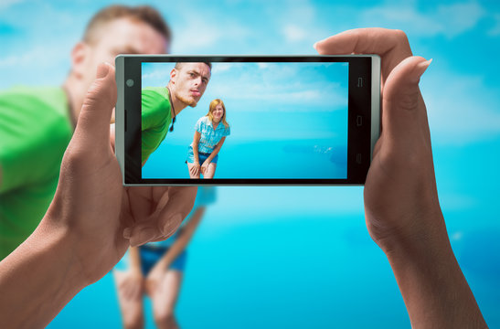 Cheerful boy and girl on a smartphone screen
