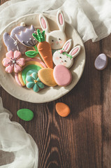 Happy Easter. Multi-colored pastel easter cookies on a wooden background.