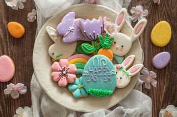 Happy Easter. Multi-colored pastel easter cookies on a wooden background.