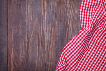 Red checkered napkin on a rustic wooden table with copy space for placing your text or product.