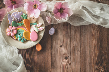 Happy Easter. Multi-colored pastel easter cookies on a wooden background.