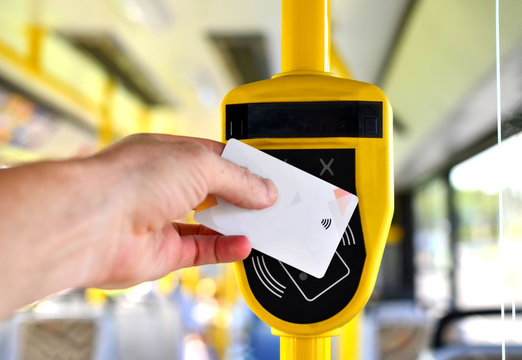 Automatic validator for reading and scanning ticket, cards and bank cards in public transport to pay for riding. Wireless contactless cashless payments, rfid nfc.