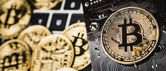 Macro closeup of bitcoins placed on a computer circuit board. Crypto currency concept.