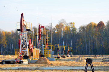 Oil drilling derricks at desert oilfield for fossil fuels output and crude oil production from the...