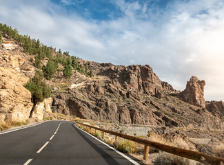 Beautiful image of narrow road going in mountains on bright sunny day