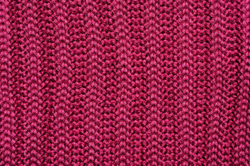 Abstract background. A fragment of a woolen knitwear in burgundy color.