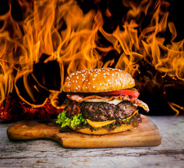 Tasty smoked grilled and glazed beef burger with lettuce, cheese and bacon served with french fries...