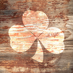 St. Patrick's Day. Light trail of three leaf clover on a wooden surface.