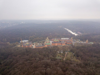 Aerial drone view. St. Pokrovsky Holosiivsky Monastery among coniferous forests