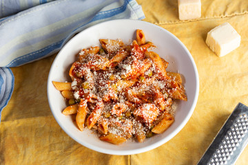 Penne pasta with tomatoes sauce and chicken and parmesan. Italian traditional dish
