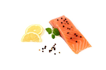 red fish fillet with lemon on white background.