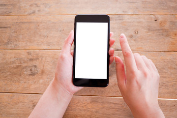 Mockup picture of business man’s hands holding smart phone with white blank screen in modern place.