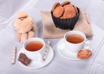 Sweet snacks and cup of tea on the table