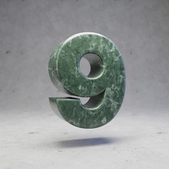 Green marble number 9 on concrete background