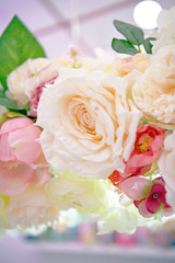 Lots of multicolored blooming roses. Beautiful flowers in bloom. Big bouquet of artificial roses. Flower background.
