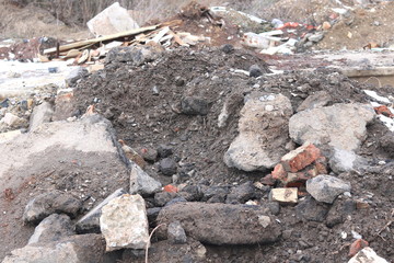 Construction waste with elements of and destroyed old structures at municipal landfill