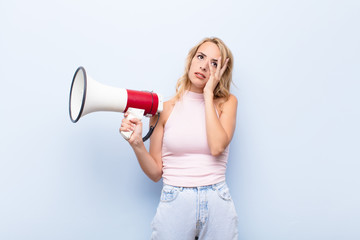 young blonde woman feeling bored, frustrated and sleepy after a tiresome, dull and tedious task,...