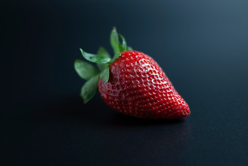 Isolated strawberry on black background