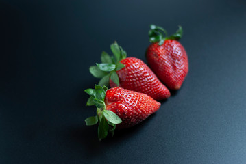 Isolated strawberries on black background