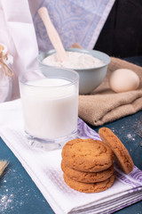 Cup of milk with cinnamon biscuits and flour