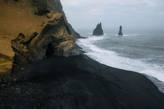 Aerial view of reynisfjara beach in iceland with seastacks and waves