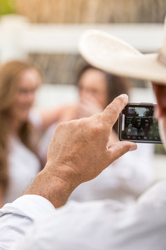 Close-up of cowboy taking picture of his family. Bridger, Montana, USA