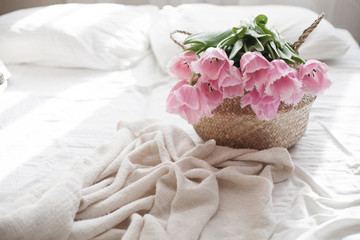 tulips in a basket at home on the sofa