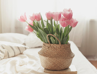 tulips in a basket at home on the sofa