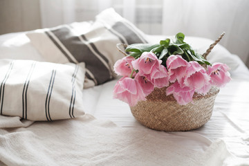 Fototapeta na wymiar tulips in a basket at home on the sofa
