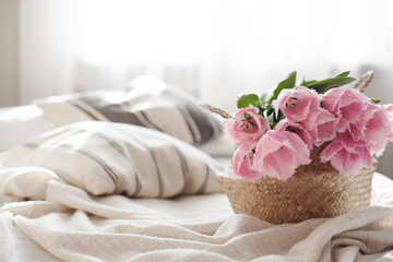 tulips in a basket at home on the sofa