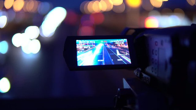 Bokeh - A footage of a camera that captures busy cars on a highway on a dark night. Car lights blurry in the background.