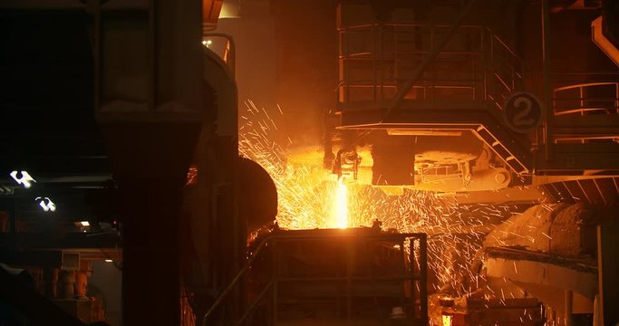 Liquid metal in the factory, foundry, smelting iron and processing. Iron and Steel Works. Pouring of molten iron.