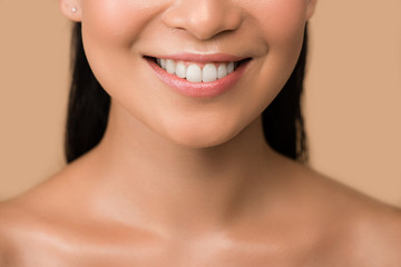 Obraz premium cropped view of smiling beautiful naked asian girl isolated on beige