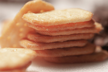 Close-up of a snack with cheese. A stack of dry cookies.