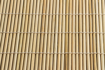 Texture of yellow and olive bamboo mat for sushi, close-up, macro, top view