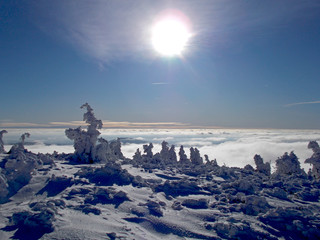 Sun shining on snowy mountain in czech republic
