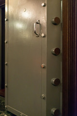 Opened old-fashioned solid vault door of a bank.